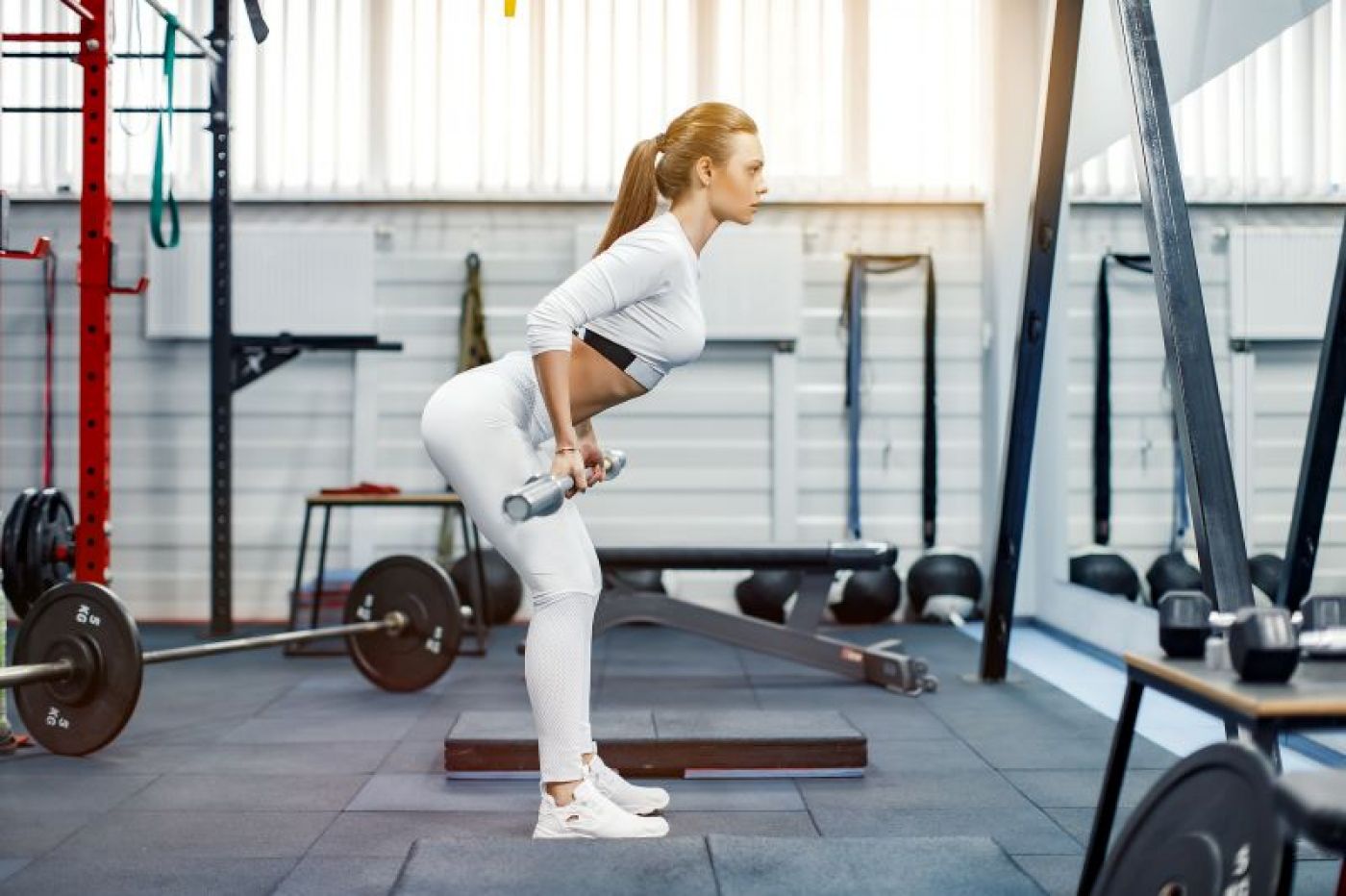 Femme soulevant des poids dans la salle de gym