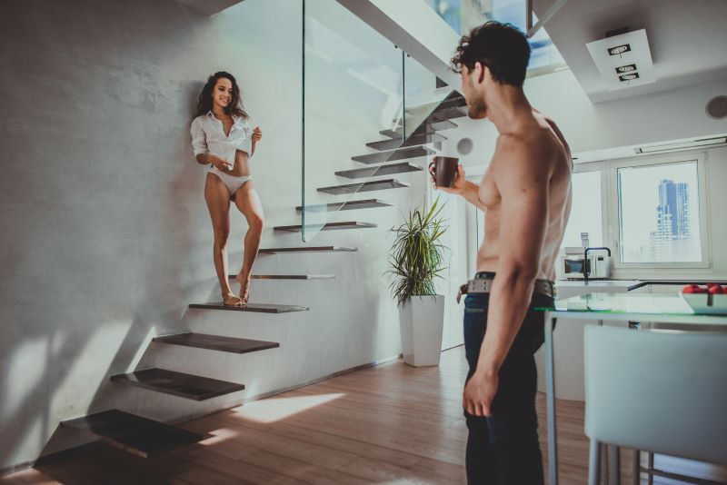 Couple drinking tea and flirting at home